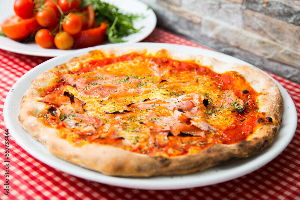 Prosciutto Pizza. Neapolitan pizza with tomato sauce, cheese and prosciutto ham. Authentic Italian recipe. Prosciutto Pizza. Neapolitan pizza with tomato sauce, cheese and prosciutto ham. Authentic Italian recipe.