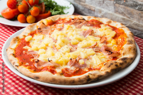 Prosciutto and pineapple Pizza. Neapolitan pizza with tomato sauce, cheese and prosciutto ham. Authentic Italian recipe.
