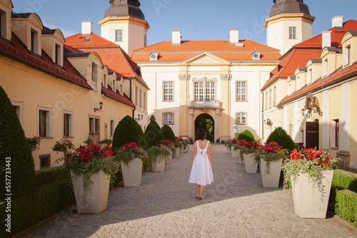 The girl looks at the courtyard of the castle. Architecture of an old Jewish building.