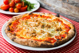 Tuna Pizza. Neapolitan pizza with mozzarella cheese, tuna, onion and olives. Authentic Italian recipe.