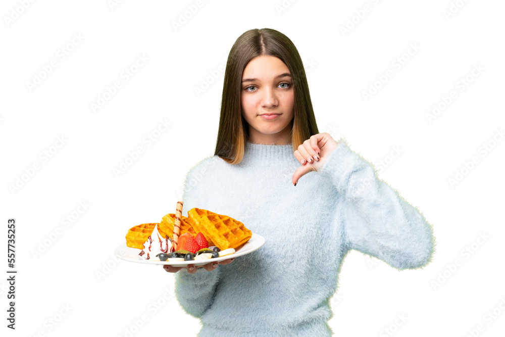 Teenager girl holding waffles over isolated chroma key background showing thumb down with negative expression Teenager girl holding waffles over isolated chroma key background showing thumb down with negative expression