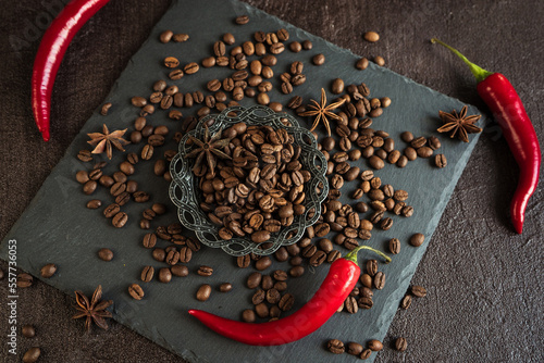 aromatic coffee beans in a metal Turkish bowl, anise with bitter hot chili pepper on a black background 2