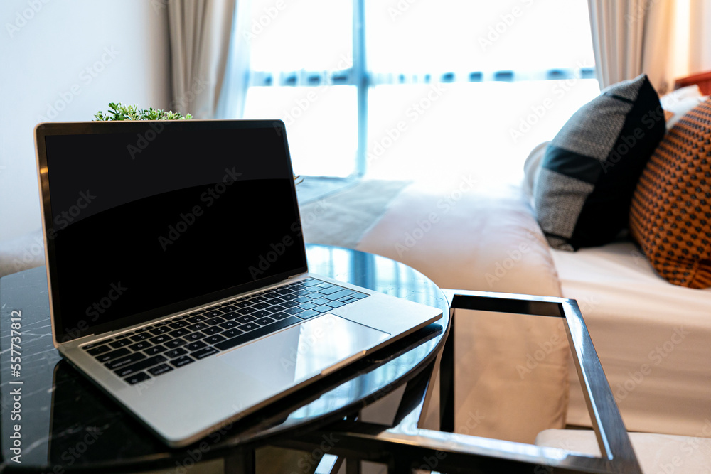 Fototapeta premium notebook computer set on the table in front of the sofa