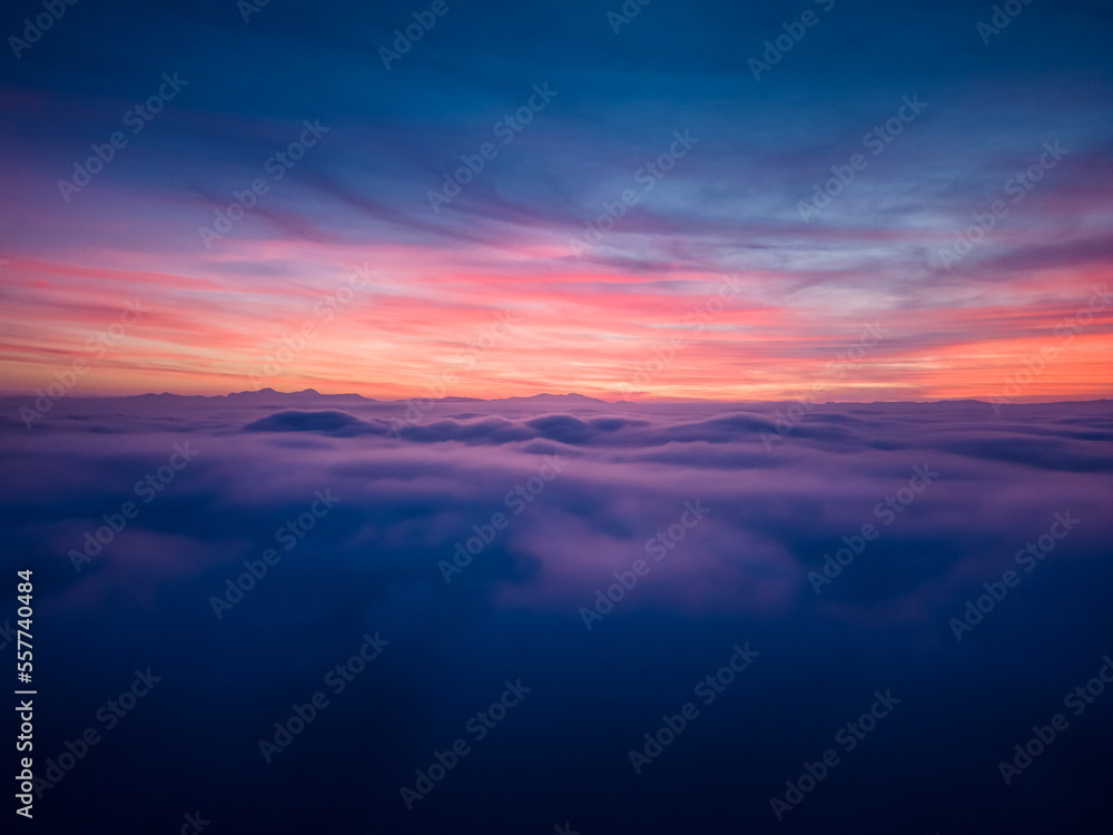 aerial view above the clouds at sunset