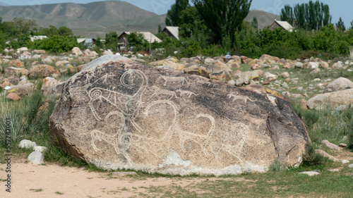 Petroglyph in Kyrgyzstan. An ancient rock carving and engraving known as petroglyphs created by indigenous people thousands of years ago photo