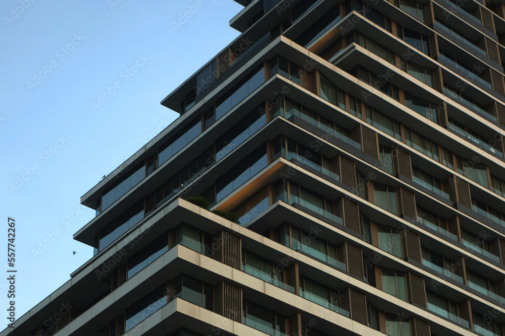 Modern urban apartment building exterior in evening.