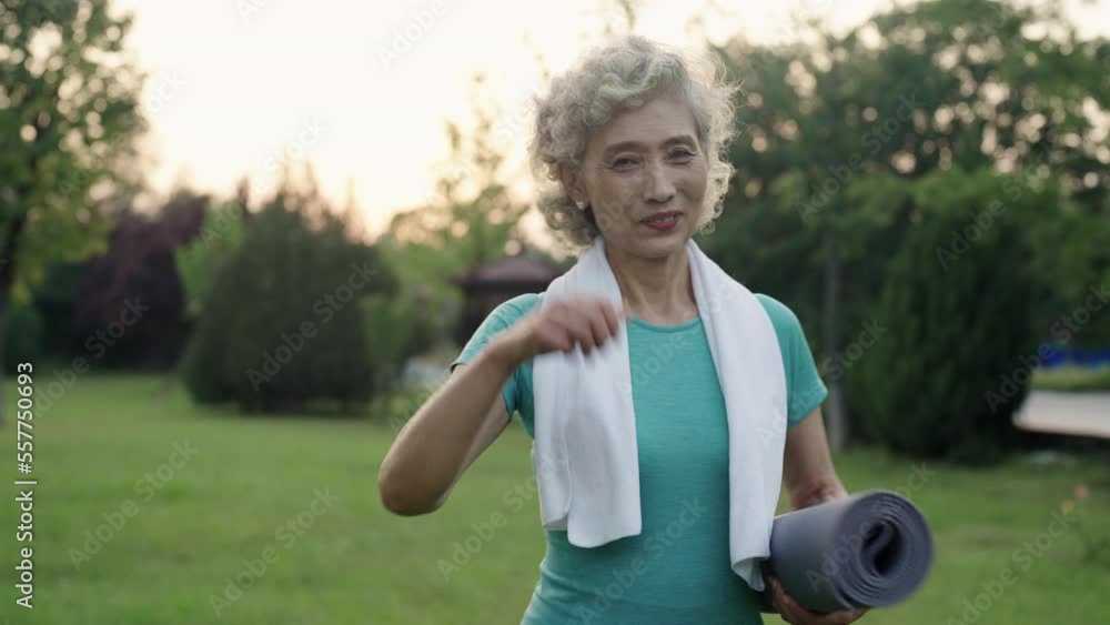 Happy senior Chinese woman exercising in park,4K Happy senior Chinese woman exercising in park,4K