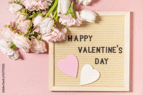 Wallpaper Mural Happy Valentine's Day lettering on letter board and beautiful spring flowers on light pink background. Valentine's day, Womans day, mothers day greeting card. View from above. Torontodigital.ca