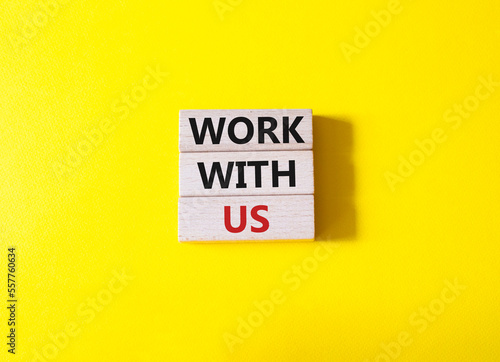 Work with us symbol. Wooden blocks with words Work with us. Beautiful yellow background. Business and Work with us concept. Copy space.