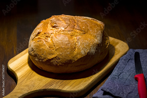 Traditional round loaf of bread on a wooden table