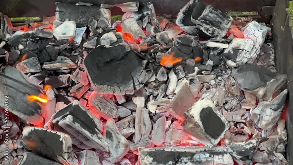 Motion of flame over the charcoals close-up slow motion Motion of flame over the charcoals close-up slow motion