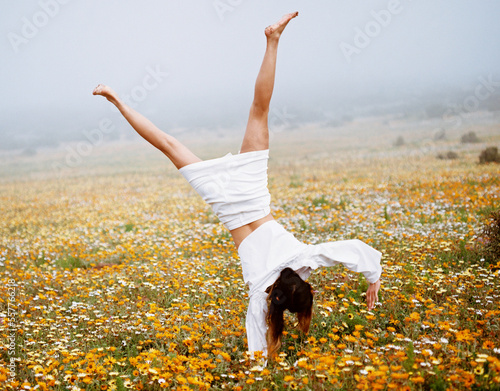 woman cartwheel in field