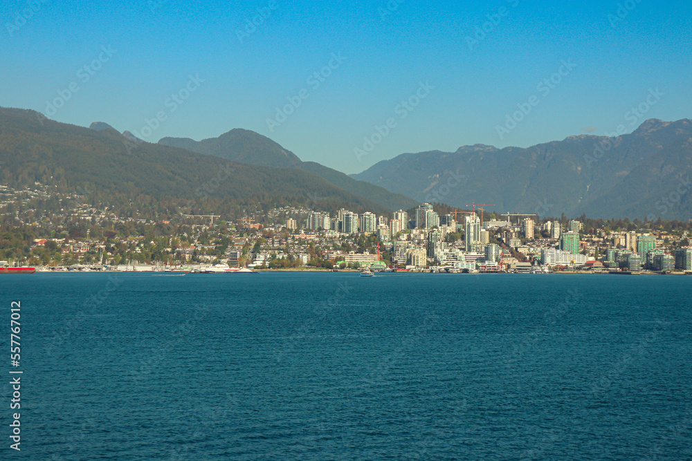 North Vancouver BC cityscape skyline view from across the water at Burrard Landing - Canada Place during a clear sky day