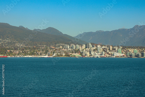 Fototapeta Naklejka Na Ścianę i Meble -  North Vancouver BC cityscape skyline view from across the water at Burrard Landing - Canada Place during a clear sky day