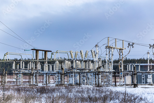 High voltage vintage electrical substation in Ukraine in winter. Wiring, connections and insulators. Russian missile attacks on Ukrainian energy during war. Shutdown. Power plant.