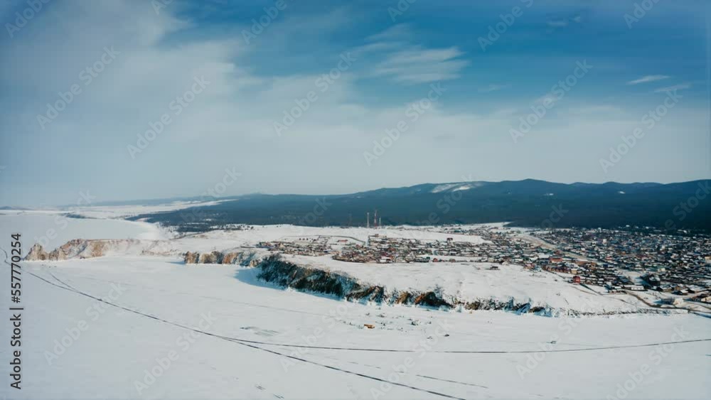 Olkhon, Khuzhir, Baikal. Panorama of the island from a drone. The snow-covered desert. Winter village in the background on the mountains. Drone aerial shot Olkhon, Khuzhir, Baikal. Panorama of the island from a drone. The snow-covered desert. Winter village in the background on the mountains. Drone aerial shot