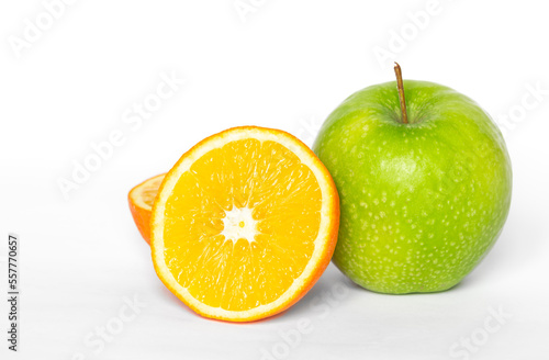 Green apple and orange on a white background isolated.
