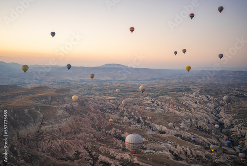 Views of Cappadocia from above, hot air balloons over the valley at dawn