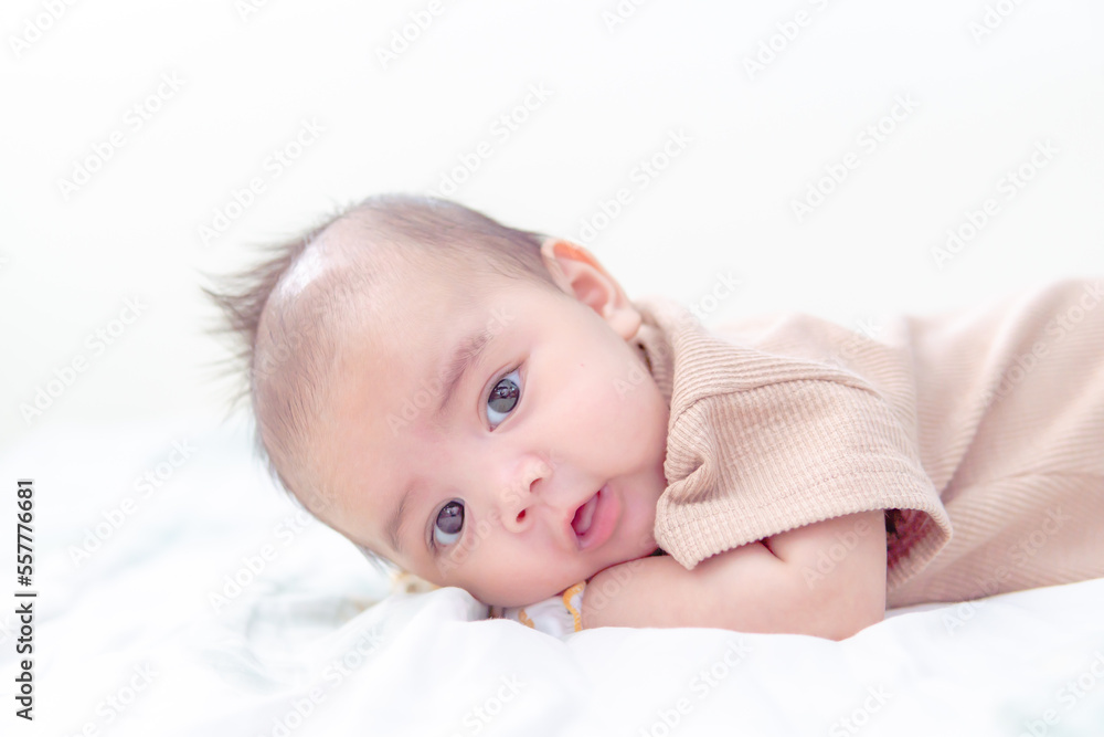 Cute little 3 month, and looking up in prone position, prone baby newborn development training. Cute little 3 month, and looking up in prone position, prone baby newborn development training.