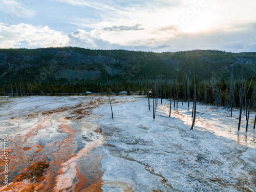 Fountain Paint Pot trail between geyser, boiling mud pools and burnt trees in in Yellowstone National Park in Wyoming photo