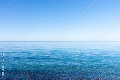 Ocean sky horizon line blends into infinity with blue turquoise colors of ocean waters and cloudless sky