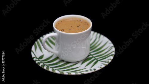 Turkish and Arabic Traditional Hot Coffee or Espresso Drink on rustic wood bar counter, black bacgraund photo