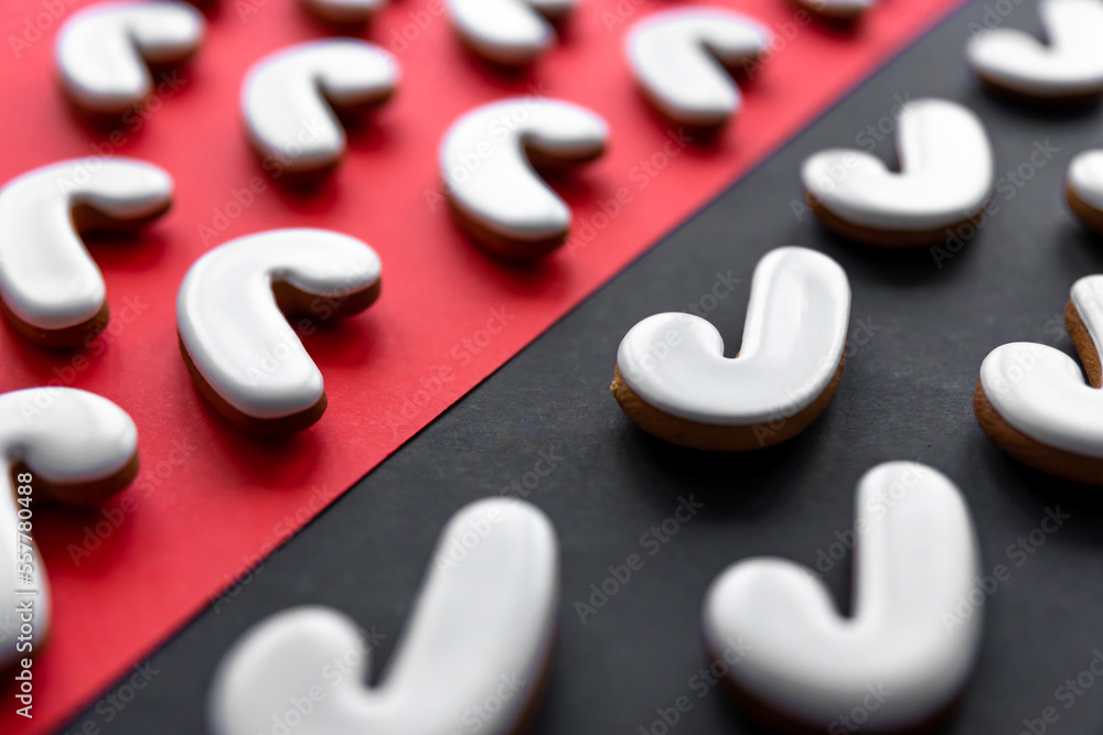 A lot of gingerbread candy cane shaped cookies on a colored background. A lot of gingerbread candy cane shaped cookies on a colored background.