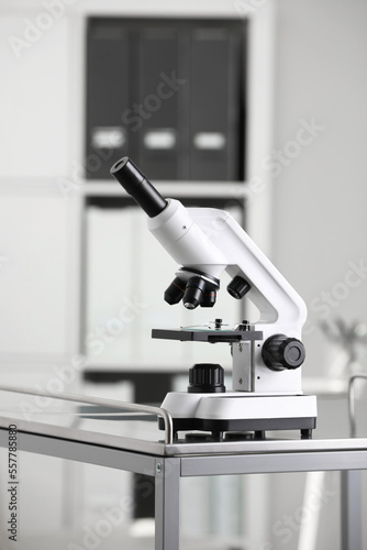 Modern medical microscope on metal table in laboratory