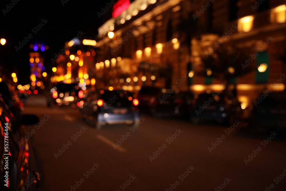 Blurred view of city street with lights at night. Bokeh effect