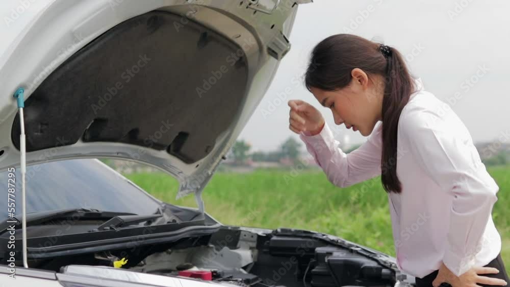 Asian woman, broken car parked on the side of the road Open the bonnet and look at the engine. Transportation concept. car insurance Asian woman, broken car parked on the side of the road Open the bonnet and look at the engine. Transportation concept. car insurance