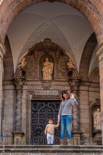 Mother and son tourists at the door of the Sanctuary of Loyola, Baroque church of Azpeitia