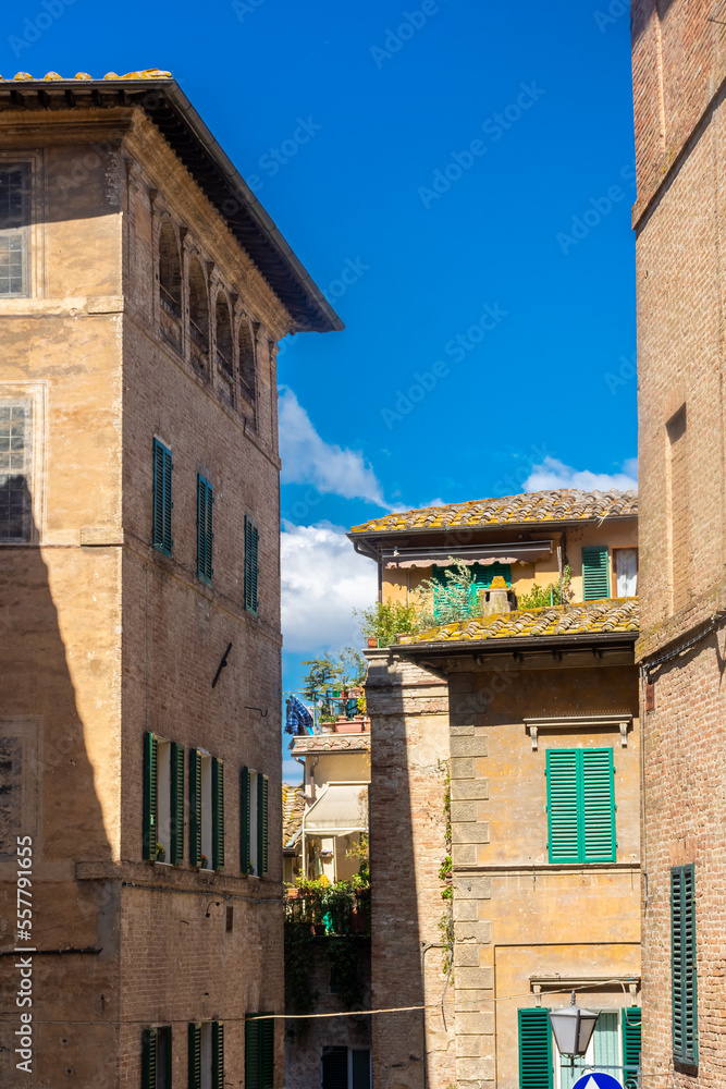 Siena, Italy, 17 April 2022:  typical street scene of the medieval historic center