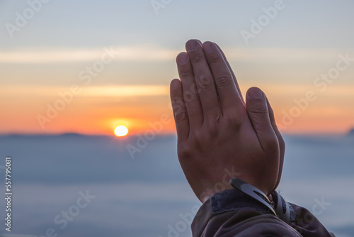 Praying hands with fog. Autumn sunny sunrise over scenic valley landscape.