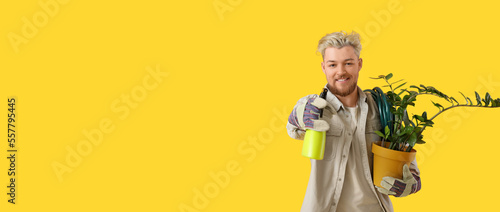 Young male gardener on yell...