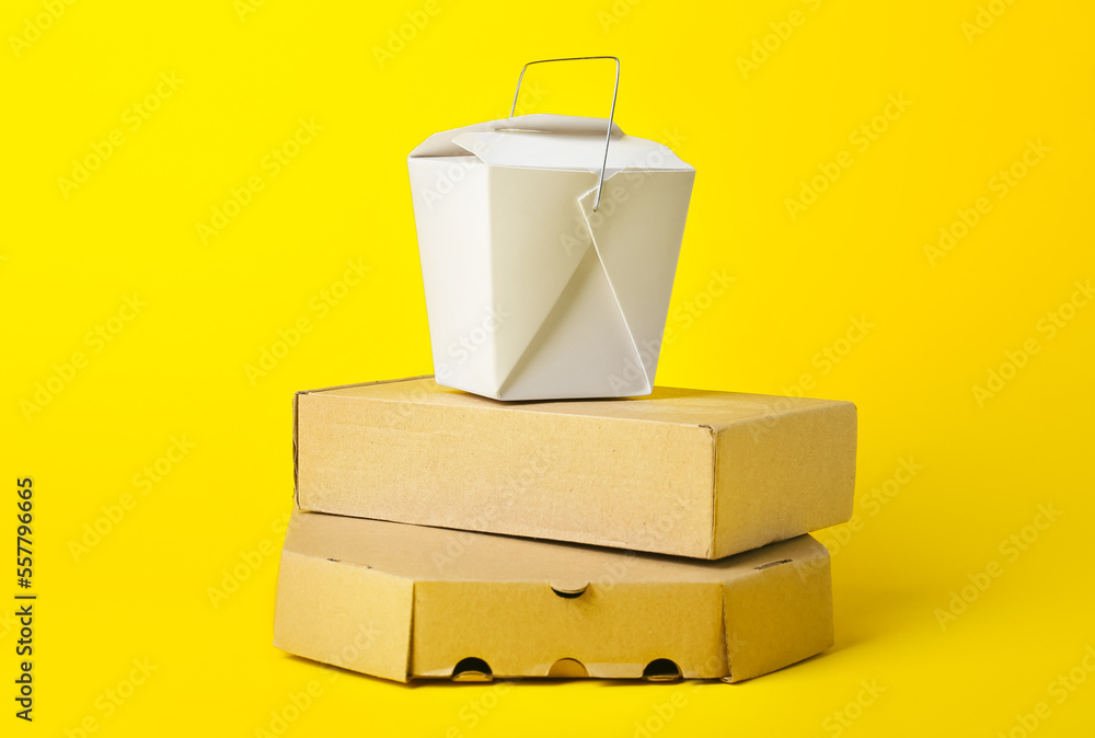 Stack of different food boxes on color background Stock Photo | Adobe Stock