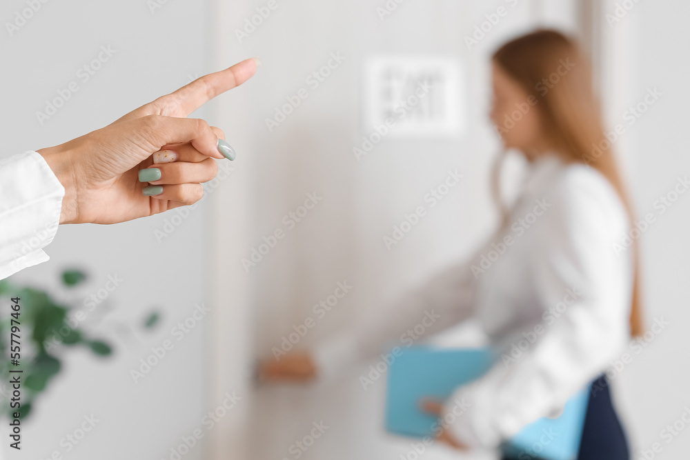 Fototapeta premium Boss dismissing her female worker in office, closeup