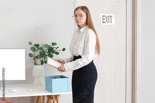 Fired young woman packing h...