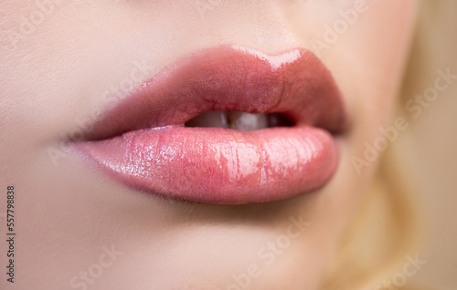 Female mouth with sexy pink lips isolated closeup. Close up woman sensual lips with red lipstick. Passionate lip.