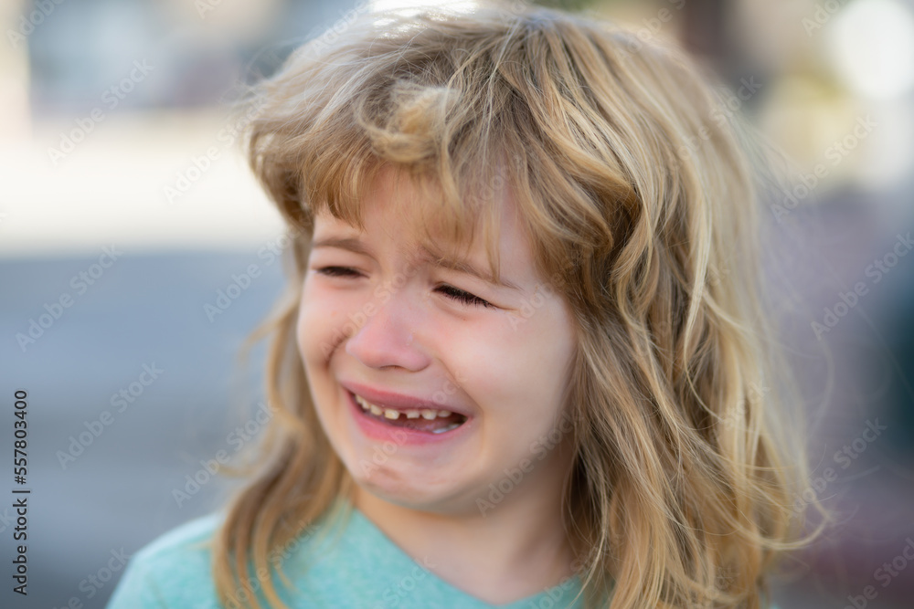 Portrait of crying kid with tears weeping emotion, hurt in pain. Tear drops on cheek. Portrait of crying kid with tears weeping emotion, hurt in pain. Tear drops on cheek.