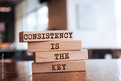 Wooden blocks with words 'CONSISTENCY IS THE KEY'.