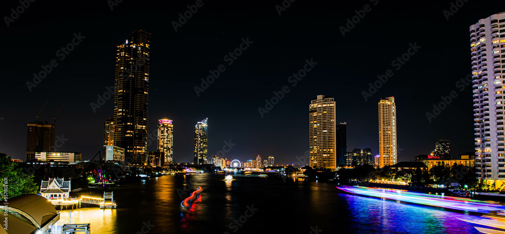 BANGKOK, THAILAND - JANUARY 1,2023 : The countdown firework show at Asiatique Riverfront in Bangkok. Colourful of fireworks on the river on Chao Praya River.