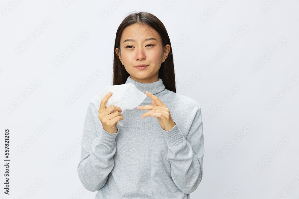 Asian woman holding hand with handkerchief and coughing up flu and cold, stuffy nose viral disease covid 19 white background Asian woman holding hand with handkerchief and coughing up flu and cold, stuffy nose viral disease covid 19 white background