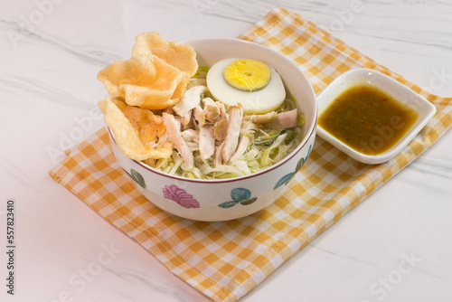 Chicken Soto with chili sauce or Soto Ayam in Indonesia. Soto ayam is a traditional Indonesian food photo