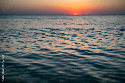 Close up of sea surface on sunset. Water background