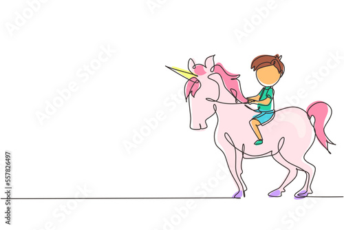 Continuous one line drawing happy cute boy riding cute unicorn. Child sitting on back unicorn in fairy tale dream. Kids learning to ride unicorn. Single line draw design vector graphic illustration