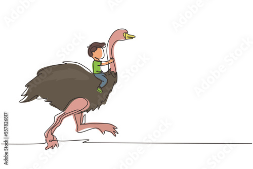 Single continuous line drawing happy little boy riding cute ostrich. Child sitting on back ostrich with holding its neck. Kid learning to ride ostrich. One line draw graphic design vector illustration photo