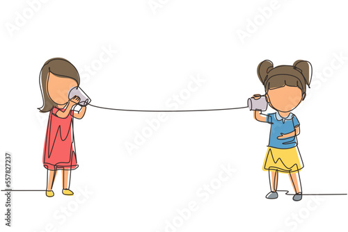 Single one line drawing girls speaking by tin can telephone. Two friends playing in phone with self made speech transmitting device, kids have fun speaking. Continuous line draw design graphic vector photo