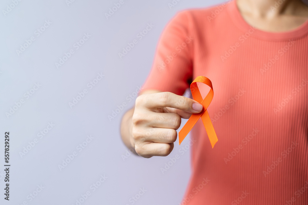 Fototapeta premium Orange Ribbon for Leukemia, Kidney cancer day, world Multiple Sclerosis, CRPS, Self Injury Awareness month. Healthcare and word cancer day concept
