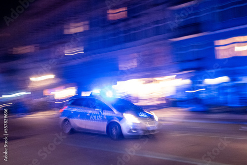 Patrol car of the Berlin police drives with blue lights to a mission through Oderberger Straße in Berlin-Prenzlauer Berg on New Year's Eve.