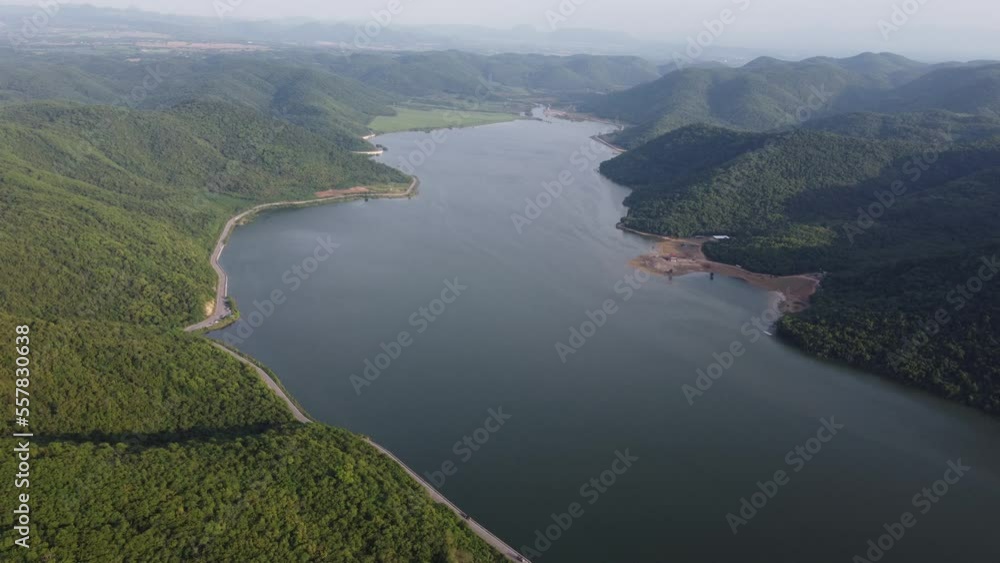 Muak Lek reservoir in Saraburi from aerial bird eye view. Beautiful unseen nature at Muak Lek dam with roadway beside with water and tree hill. Muak Lek reservoir in Saraburi from aerial bird eye view. Beautiful unseen nature at Muak Lek dam with roadway beside with water and tree hill.